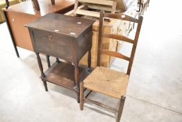 A traditional ladderback low seat chair and a stained sewing or similar work table