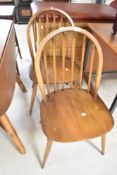 A pair of Ercol mid stain hoop and stick back dining chairs