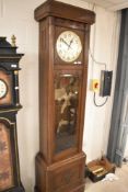 An early 20th Century oak longcased clock having silvered dial with Arabic numerals, with brass