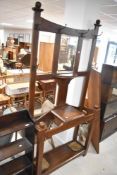 An early 20th Century oak hall stand, having Arts and Crafts style coat hooks, height approx. 200cm,
