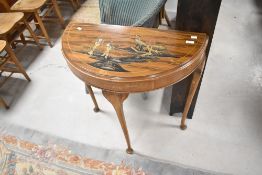 A vintage Japanesque demi lune side table with raised gilt decoration, width approx. 75cm