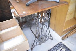 A vintage sewing machine table with later top, approx. 82 x 59cm