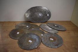 A selection of vintage silver plated placemats including six round, one large and two medium oval