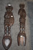 A pair of mid 20th century large fork and spoon plaques, modelled as medieval knights, hand carved