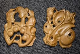 Two stylised wooden wall art sculptures one depicting two women and the other depicting flowers 40cm