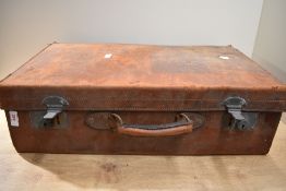 A early 20th century brown leather suitcase, w60cm. A/F.