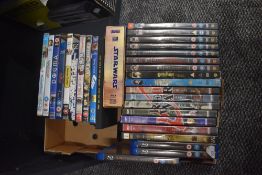 A carton of approximately thirty assorted DVDs including six of the Harry Potter series, Star Wars-