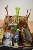 A vintage green glass vase, two hand carved African deer and a similar Giraffe, a wooden Eeyore