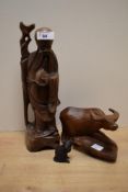 A 20th century carved Chinese rosewood figure of a bearded immortal clutching his staff and bag,