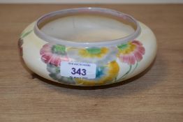 A Clarice Cliff crewport pottery bowl, hand painted with flowers on a cream ground, signed to