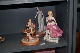 A group of three female figures, to include Cinderella by Franklin Mint, h26cm, a Jane Austen's Emma