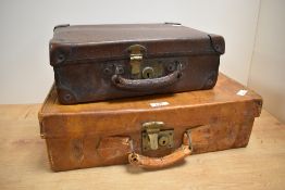 A vintage vellum / leather suitcase having brass fixtures, cloth interior and initials for Colin
