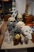 A group of ten decorative model skulls in various colour-ways and sizes, the largest measuring
