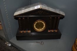 A 19th century black slate 8-day mantel clock having Arabic chapter ring dial, flanked either side