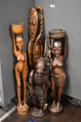 A group of hand carved wooden African tribal sculptures in traditional dress, ( 4 )