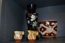 A late 19th century black opaque glass vase, decorated in the aesthetic style, having hand painted