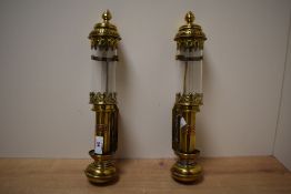 A pair of GWR carriage lamps having glass cylindrical chimneys and brass covers, L36cm