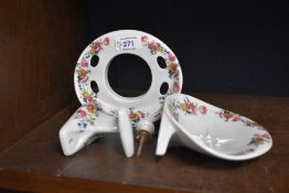 Three porcelain Italian bathroom wall mounts decorated with floral patterns.