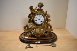 A 19th cenetury French gilt metal striking mantel clock, having a figural surmount over the enamel