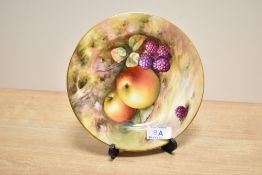 A hand painted Royal Worcester porcelain plate, decorated with fallen berries and peaches against
