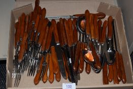 A box containing George Wostenholm & Sons stainless steel cutlery, designed having teak handles, the