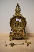 A late 19th 8-day mantel Boulle clock with key, decorated having ebonised case with brass and red