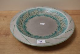 An early 20th century Royal Lancastrian lapis ware bowl painted with green motifs on a grey