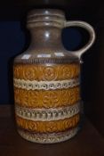 A large 1970's West German pottery handled vase/jug, decorated with bands of moulded repeating