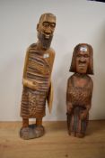 A pair of wooden African sculptures, hand carved with shield, missing spear, largest h63cm, ( 2 ).