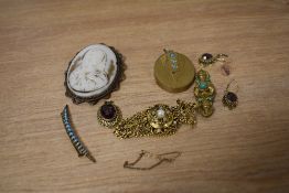 A large cameo brooch depicting The Virgin Mary, along with turqouise set pieces and a purple paste