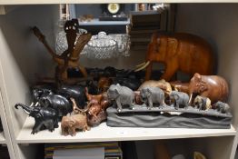 A large carved hardwood elephant figure with tusks, h30cm, sold together with various other