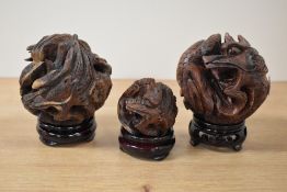 A set of 3 Chinese Zodiac Horoscope Astrology carved dragon balls on circular stands, largest w9cm