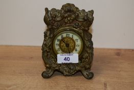 An early 20th century desk clock in the Rococo style, having gilt and enamel dial , black numerals