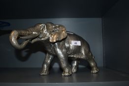 A large cast and plated metal elephant study 18.5cm high