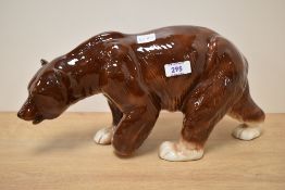 A large ceramic study of a brown bear, striding on all fours, makers mark for 'Charisma, made in