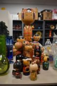 An assortment of vintage Japanese Kokeshi wooden dolls, the largest measuring 60cm tall.