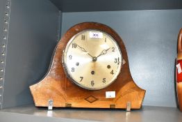 An Art Deco chiming mantel clock having inlaid walnut case with chrome plated feet, bezel and