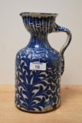 A continental earthenware olive jug, decorated with hand painted acanthus leaf on a cream ground,
