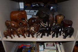 A large carved hard wood elephant with bone tusks, h26cm, sold together with various other