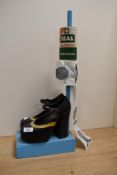 A toilet paper holder in the form of woman platform shoes, to include Izal medicated paper and