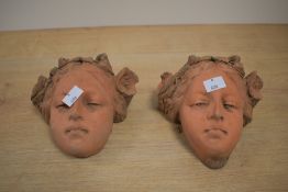 A pair of cast terracotta female wall hanging busts, h14cm