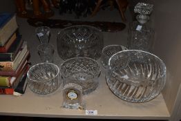 A selection of cut glass items comprising decanter, mantel clock and bowls of various sizes etc.