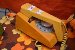 A retro Trimphone in two tone yellow with bakelite terminal box, L19cm