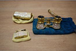 A pair of 20th century brass theatre binoculars having folding handle with mother of pearl inlay,