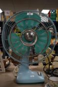 An early 20th century De Luxe Air Master electric fan in baby blue colour, h50cm