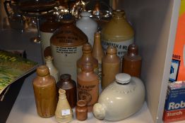 A selection of stoneware jugs and glasses including one titled 'Stantons (Bolton) Ltd' Botanical
