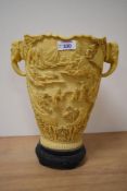 A large reproduction simulated ivory vase, of Chinese design and moulded in relief, with elephant