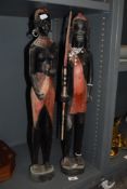 A pair of decorative African carved wooden tribal make and female figures, 62cm high.