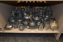 A large group of pewter tankard mugs having hammer beaten patterns, sold together with various other