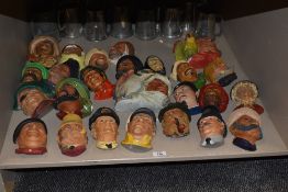 An large assortment of vintage cask chalk bosson heads depicting sailors, policeman etc.